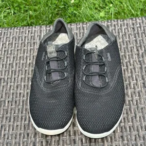 OluKai Black Sneakers with Breathable Mesh and Slip-On Design